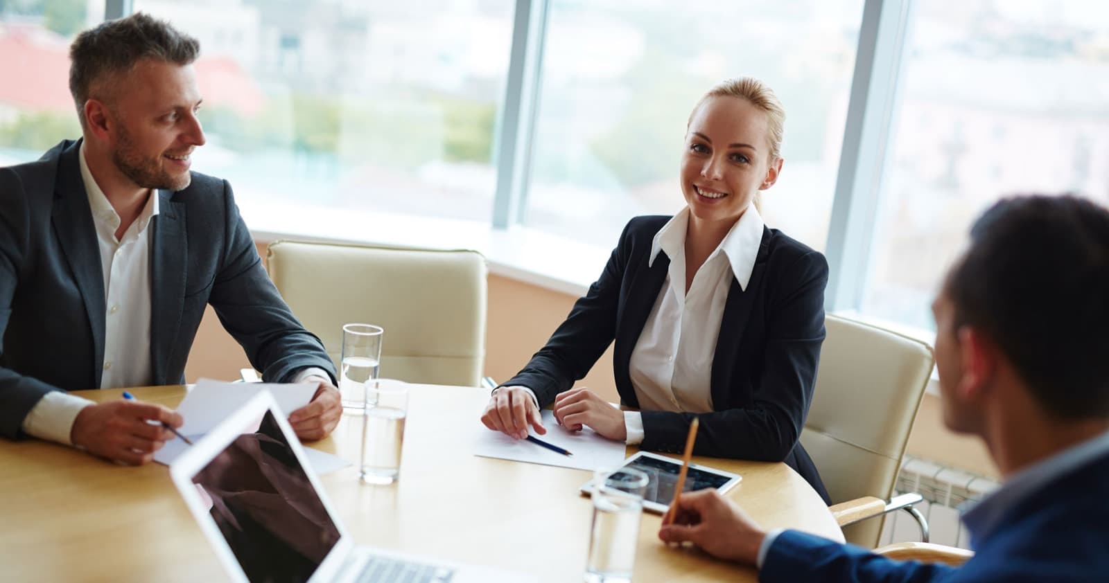 Smiling executive in a boardroom meeting about an investor website